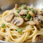 Spaghetti pasta topped with mushrooms, parmesan, and herbs.