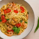 15-minute garlic butter shrimp pasta with juicy shrimp, chili flakes, and fresh parsley in a white bowl