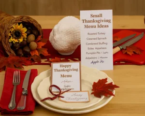 Small Thanksgiving menu with turkey breast, potatoes, pumpkin pie, and cranberry punch on a cozy table