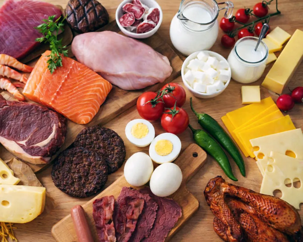 Keto diet foods for beginners including salmon eggs chicken cheese and vegetables.